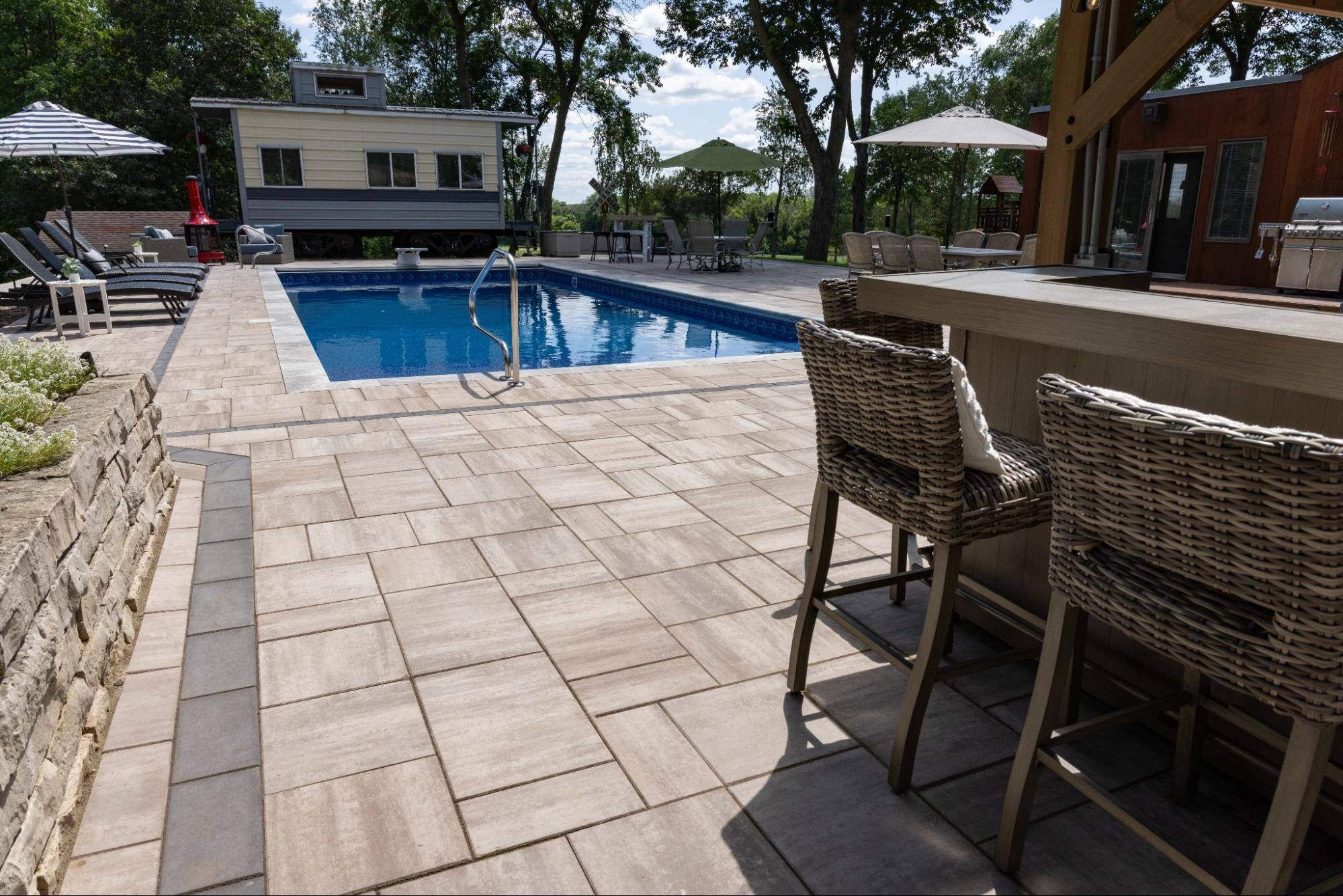 view of an in-ground pool from an outdoor bar