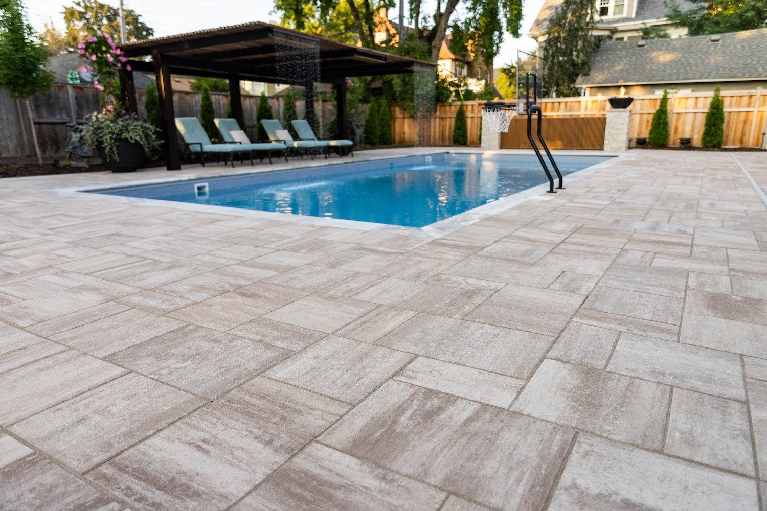 close up shot of beautiful hardscaped pavers surronding an in-ground pool