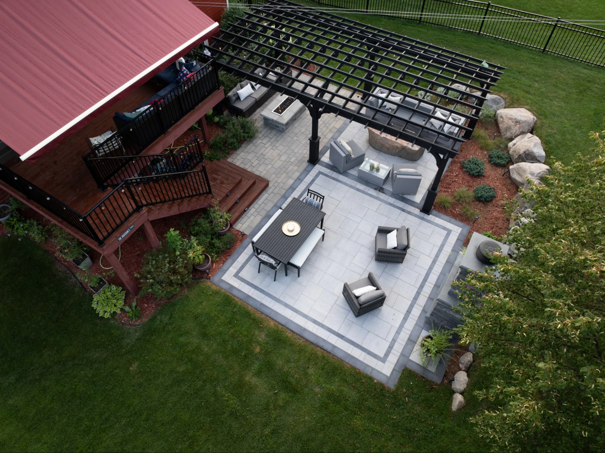an aerial view of a backyard space divided into zones using hardcape patterns.