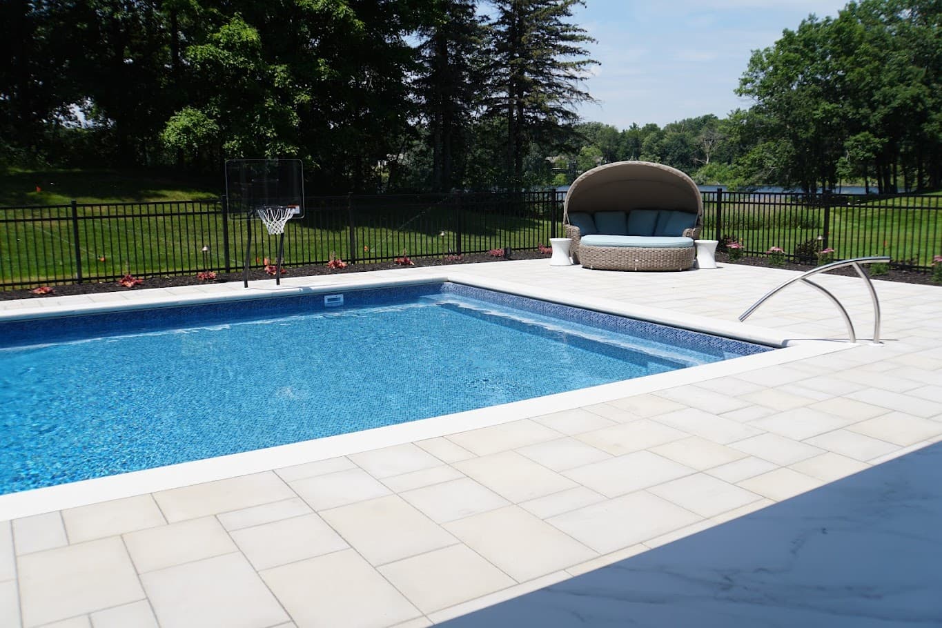 a view of a pool with built-in benches along the side