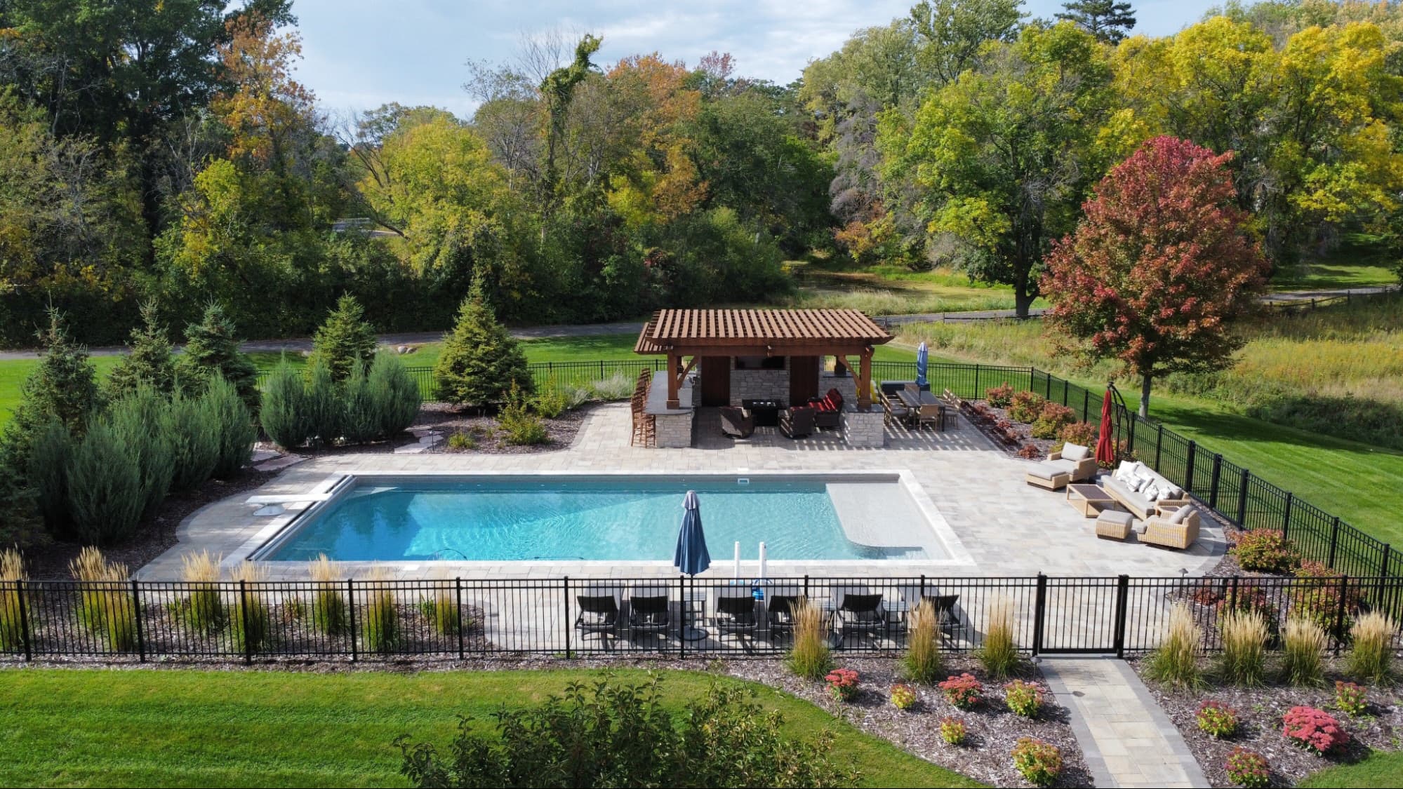 in-ground pool with nearby pergola