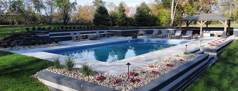a rock garden near a backyard pool