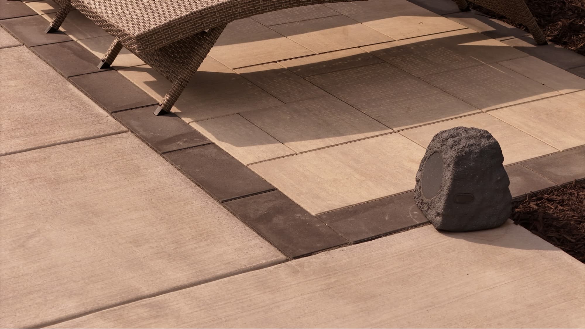 close-up of warm brown pavers surrounding an in-ground pool