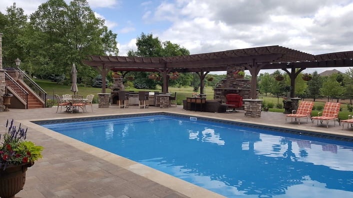 Pool with outdoor kitchen and living