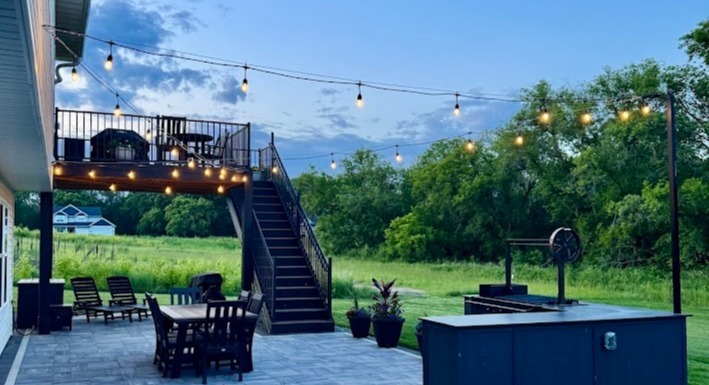 a deck with string lights surrounding it