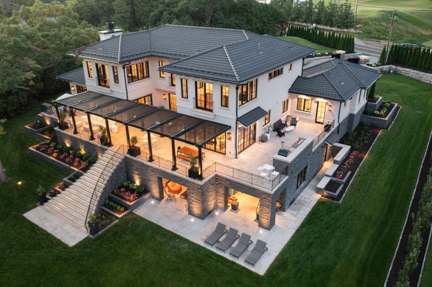 birdseye view of a luxurious mansion, with a wraparound porch