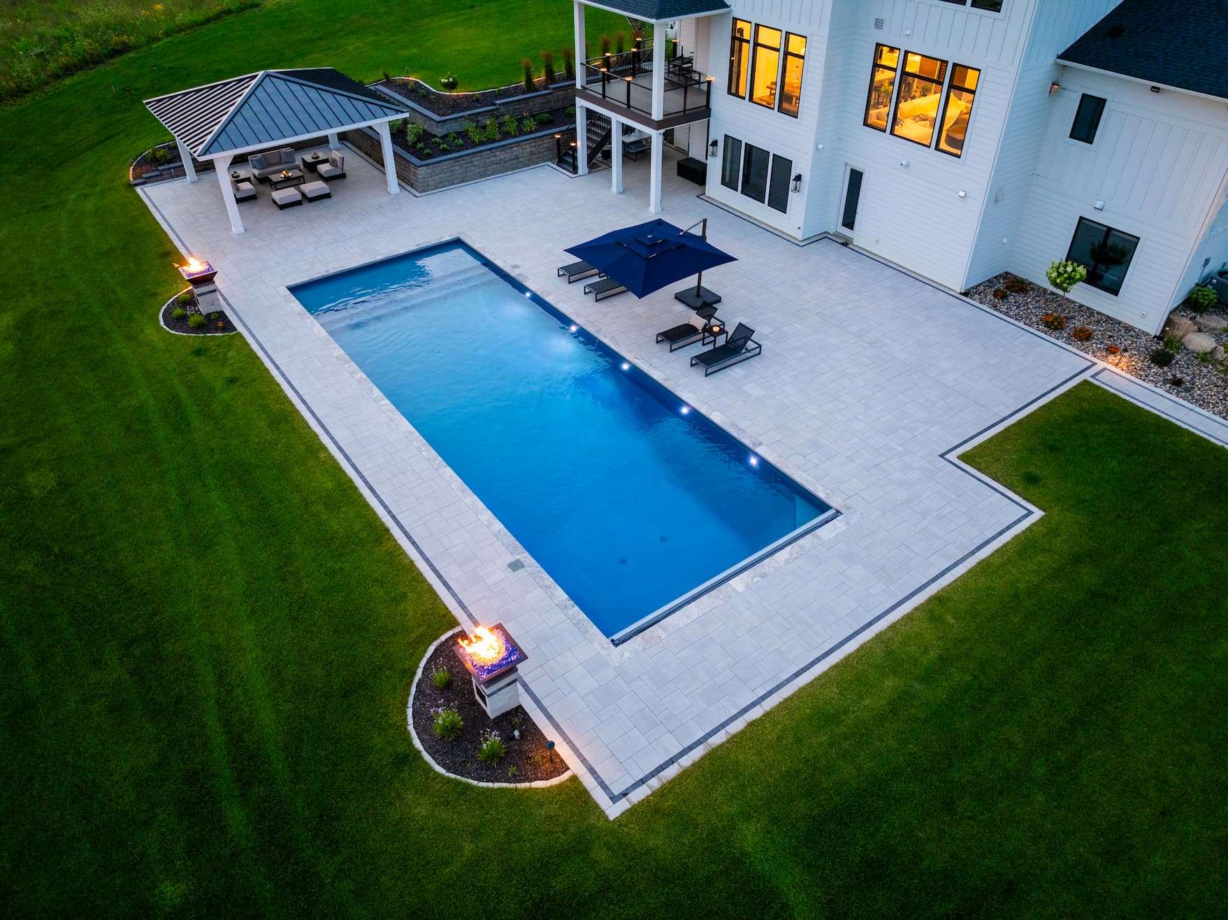 gorgeous outdoor pool with custom pavers and a pavilion