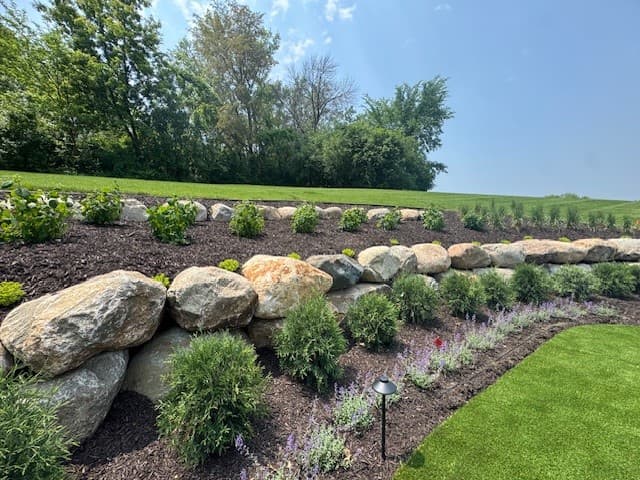 a retaining wall with rock garden