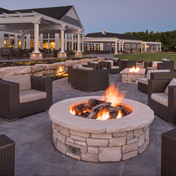 a large fire pit surrounded by chairs