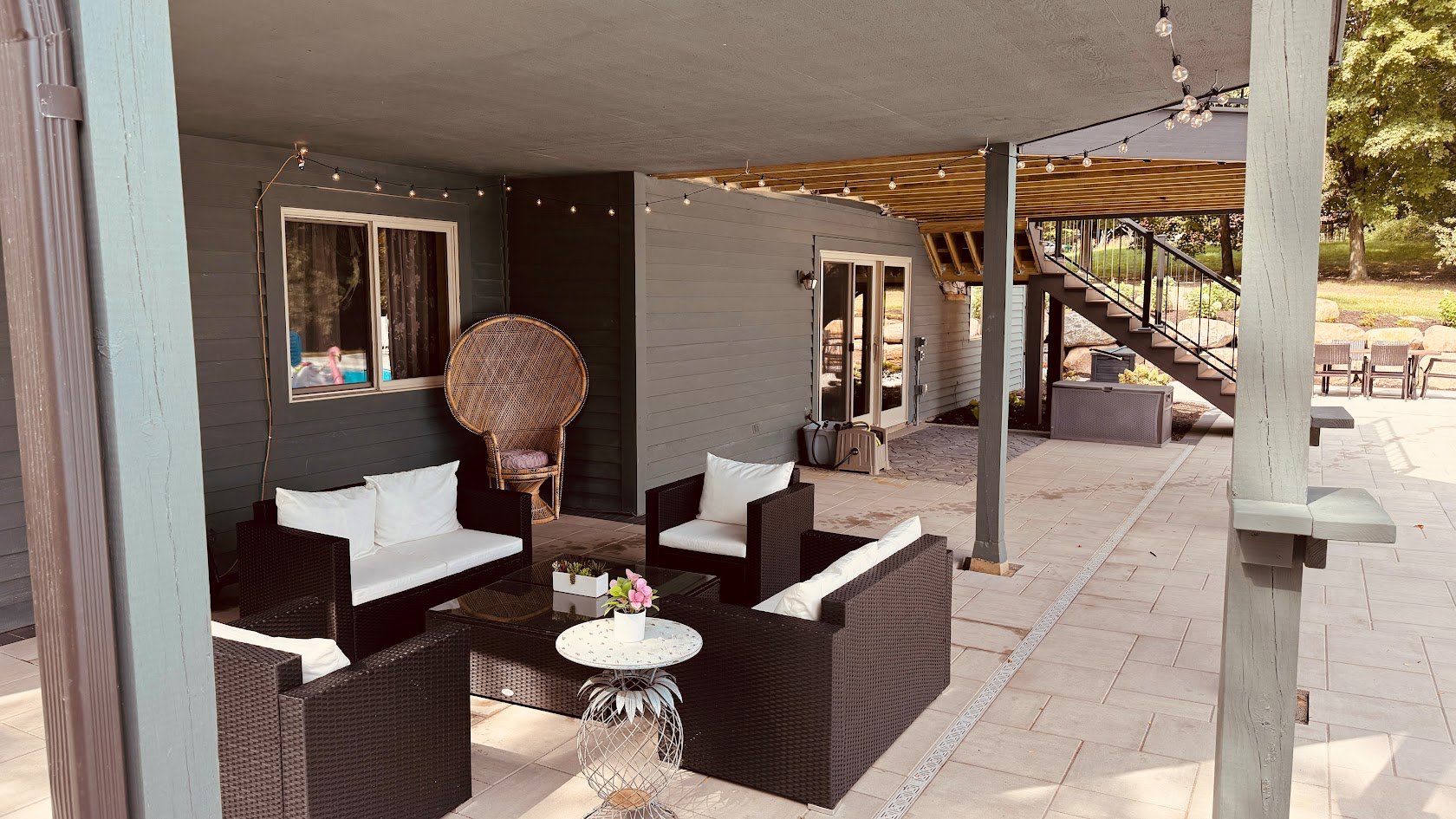 a cozy patio with outdoor couches and string lights