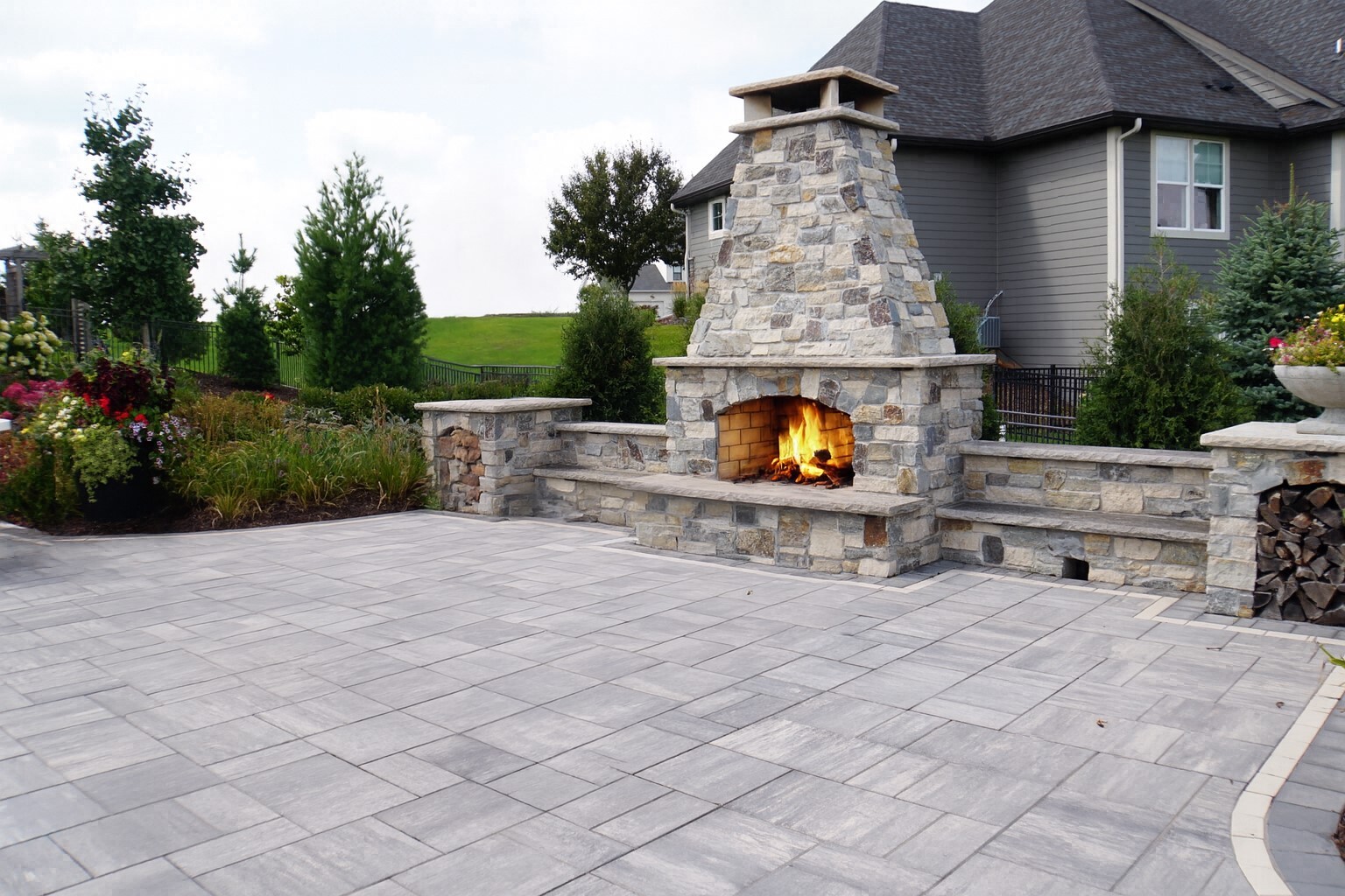 an outdoor fireplace with a burning fire